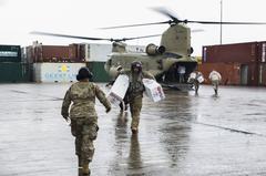 U.S. service members unloading relief supplies from a CH-47 Chinook helicopter in Dominica after Hurricane Maria
