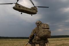 U.S. Army Capt. Gary Gorrel from 143rd Airborne Infantry Regiment awaiting chinook helicopter for air insertion with Israeli, Italian, and Polish forces during Swift Response 18 multinational exercise