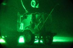 U.S. soldiers attaching generator to CH-47 Chinook helicopter for transport at Forward Operating Base Shank