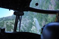 CH-47 Chinook helicopter flying over a river in mountainous Boise, Idaho during military training