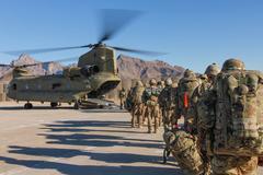 Soldiers from 101st Resolute Support Sustainment Brigade and 10th Mountain load onto Chinook helicopter in Afghanistan