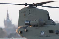 U.S. Army CH-47 Chinook helicopter exhaust heat with Saint-Martin church bell tower in Chièvres, Belgium