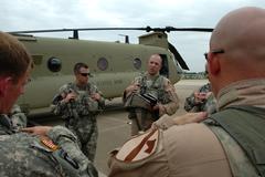 Two CH-47F Chinook helicopter pilots from the 1st Air Cavalry Brigade during a pre-flight briefing at Fort Hood, Texas, July 16, 2008