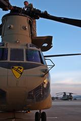 Soldier performing preflight checks on CH-47 Chinook helicopter rotor head at Fort Hood