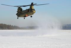 U.S. Army CH-47 Chinook helicopter landing in snowy terrain for airborne jump near Stuttgart