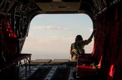 U.S. Soldier of Colorado Army National Guard viewing landscape from CH-47 Chinook helicopter during 2013 flood relief in Larimer County