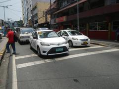 Busy intersection at United Nations Avenue and Roxas Boulevard with Carlos P. Romulo Monument in Ermita, Manila