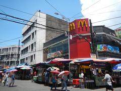 Intersection of Bautista Street and Hidalgo Street in Quiapo Manila with pedestrian activity and colorful signage