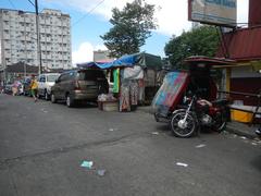 A street scene of Hidalgo Street corner A. Bautista Street in Quiapo, Manila showing buildings, power lines, and the Estero de Quiapo canal alongside the street