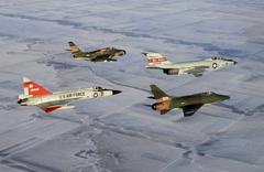 Four U.S. Air Force Air National Guard fighters in flight circa 1970 including F-102A Delta Dagger, F-84F Thunderstreak, F-101B Voodoo, and F-100D Super Sabre
