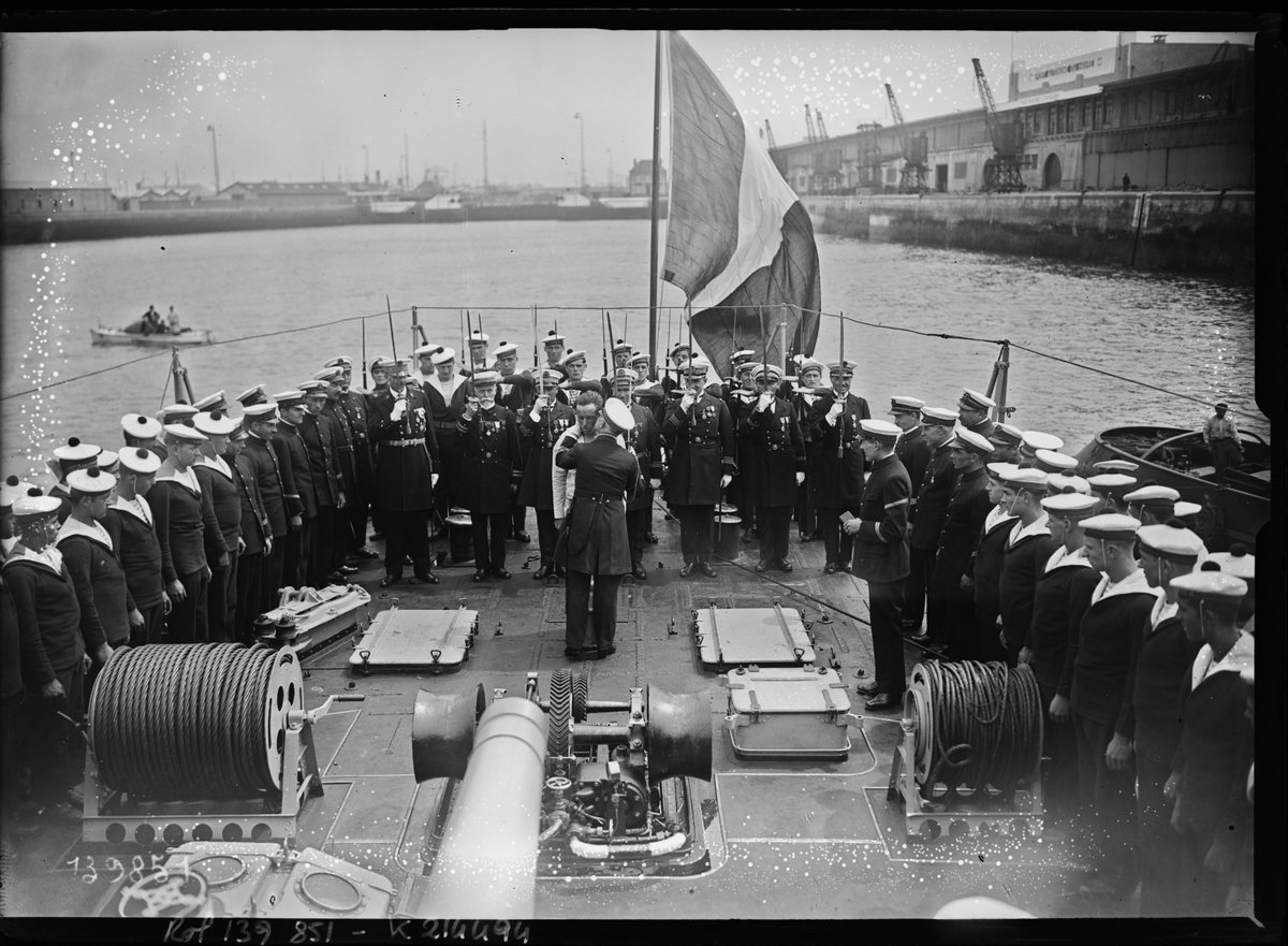 Commander Nivet decorating Alain Gerbault with the Legion of Honor on the torpedo boat 'L'Adroit' at Le Havre port, France, 1929