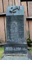 Tombstone of E. B. Schnaubelt in Trinidad California Cemetery with inscription 'Murdered by Capitalism' after rain enhancing stone colors