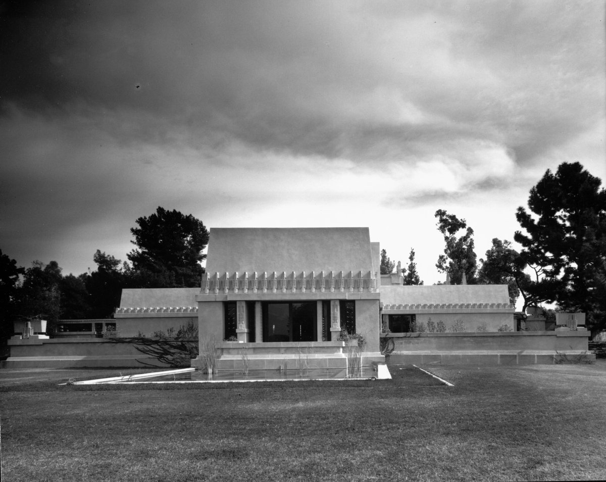 Exterior view of the Hollyhock House with large lawn and trees in Los Angeles, 1921, designed by Frank Lloyd Wright