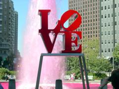 Aerial view of LOVE Park with large fountain and surrounding urban buildings