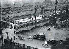 Keihan Shijo Station and train Biwako No. 61 crossing Shijo Street with Kyoto city tram waiting at the railroad crossing