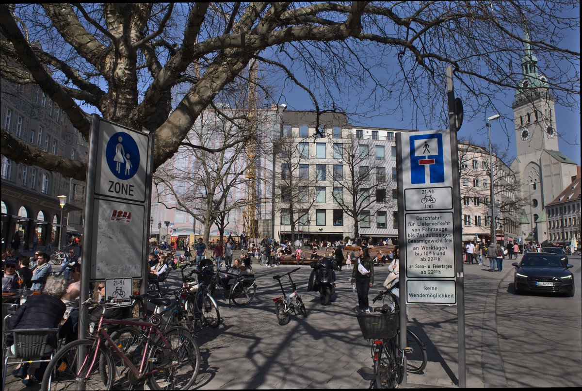 Rindermarkt square in Munich with colorful historic buildings and sunny blue sky