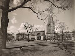 View looking north in Washington Square Park with fountain, Washington Square Arch, 1 Fifth Avenue building, and Empire State Building in the distance, Manhattan, New York City