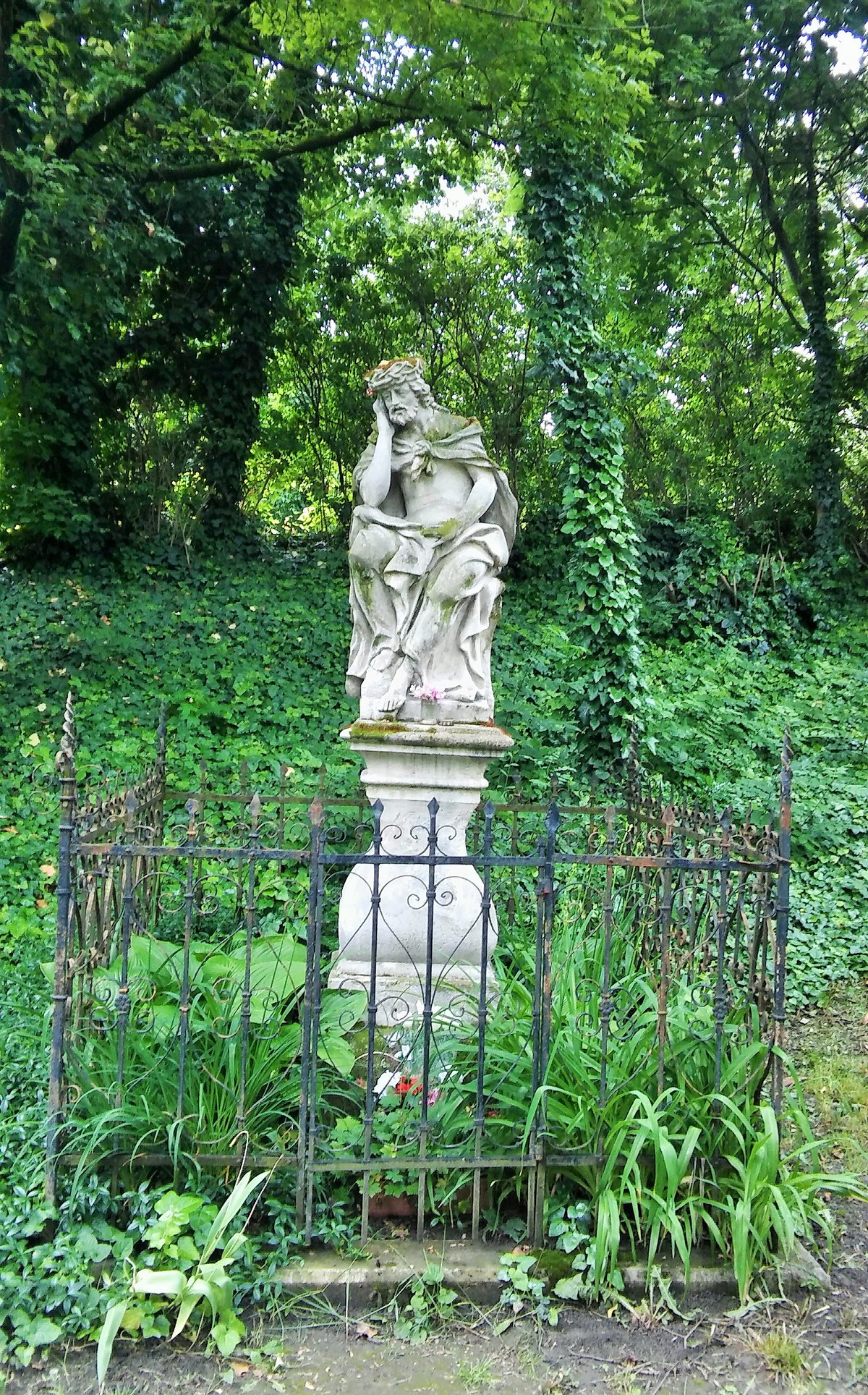 Sculpture of a Sorrowful Christ in Szilágyi Erzsébet fasor with a somber expression and detailed craftsmanship