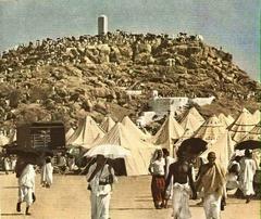 Hajj pilgrimage at Mina in 1965 showing tents, pilgrims and vehicles