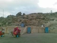 View of Jabal Rahma mountain with rocky terrain under a clear blue sky