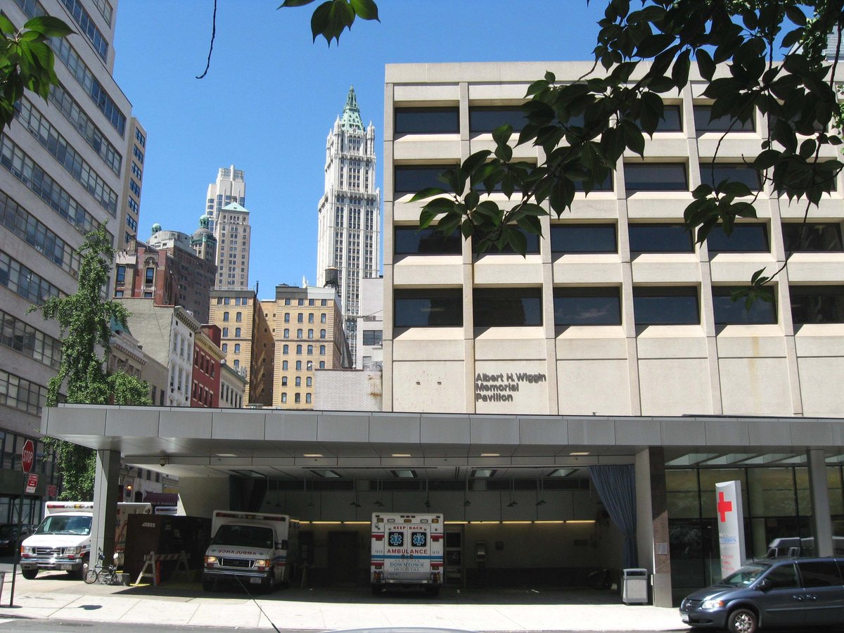 View of New York Downtown Hospital on Beekman Street looking northwest across Gold Street with the Woolworth Building in the background