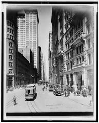 Broadway street view from Bowling Green in New York City with tall buildings and bustling city life