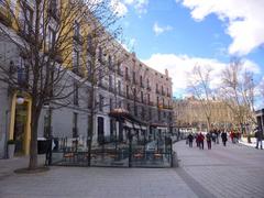 Plaza de Oriente in Madrid with historic buildings and green spaces under a clear sky