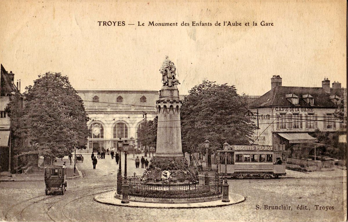 Old postcard showing the Monument des Enfants de l'Aube and Troyes train station with an electric tram engine