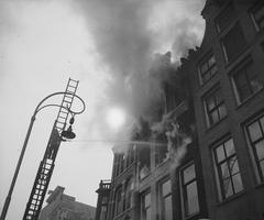 Historic fire scene with firefighters and swirling smoke on March 12, 1946