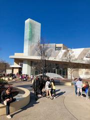 Entrance to The World of Coca-Cola museum in Atlanta, GA with branded signage and people