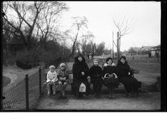Group of women and children sitting on a bench at Warsaw Zoo including Zofia Witczak-Witaczyńska and Barbara Witczak