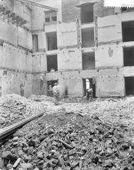 Black and white photograph of the interior of Hollandse Schouwburg being arranged as a memorial place in Amsterdam, 1960