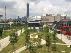 Ground level view of Cochrane Station with landscaped area and black Entrance B building
