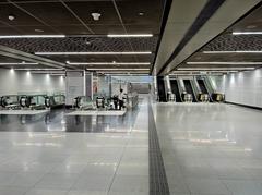 Interior of Tun Razak Exchange MRT Station concourse with commuters and escalators in Kuala Lumpur