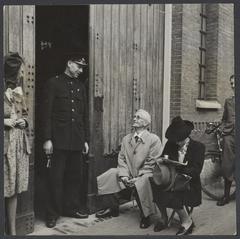 Couple watching the imprisonment of collaborators during the liberation of The Hague in May 1945