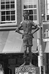 The Lieverdje sculpture on the Spui square in Amsterdam, depicting a mischievous yet kind-hearted street boy