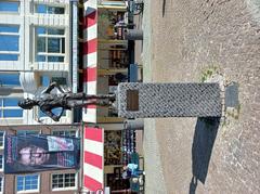 The Lieverdje statue after repair in Amsterdam 2024 with Zevenpoot advertisement behind
