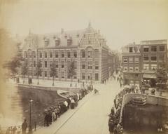 Historic view of Kloveniersburgwal with the Bushuissluis bridge and Oude Hoogstraat in Amsterdam, circa 1900