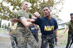 U.S. Marine instructing Filipino sailors and marines in martial arts at Naval Station Sangley Point