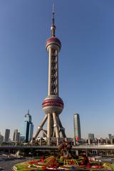 Oriental Pearl Tower in Shanghai at dusk with city skyline