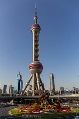 Oriental Pearl Tower in Shanghai at dusk with illuminated spheres and cityscape background