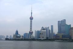 Oriental Pearl Tower at night in Shanghai China with city lights and reflections on the water