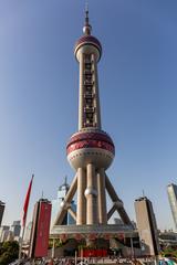 Oriental Pearl Tower in Shanghai at sunrise with reflections in the water