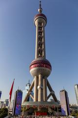 Oriental Pearl Tower in Shanghai at dusk with city skyline and river