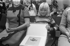 Prize winner holding award presented by Eppo Doeve at Van Gogh Museum, Amsterdam, December 20, 1973