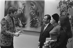 Photographer Co Rentmeester speaking with visitors during the opening of his photo exhibition about Indonesia at the Van Gogh Museum in Amsterdam on December 14, 1973