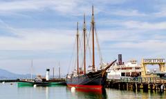 Historic sailing ships docked at Hyde Street Pier in San Francisco Maritime National Park with scenic views of San Francisco Bay