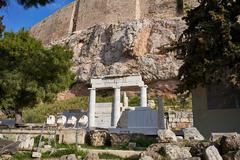 Temple of Asclepius ruins on Acropolis of Athens with Doric and Ionic columns under clear sky