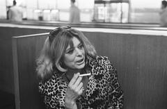 Greek actress Melina Mercouri arriving at Schiphol Airport in black and white