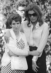 Melina Mercouri holding the wrist of Maria Elena Gaggio's mother during solemn funeral procession in Athens